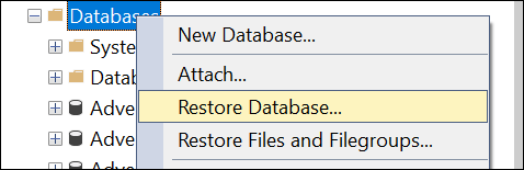 Selecting Databases mode in SQL Server Management Studio (SSMS) and opting for the Restore Database function.